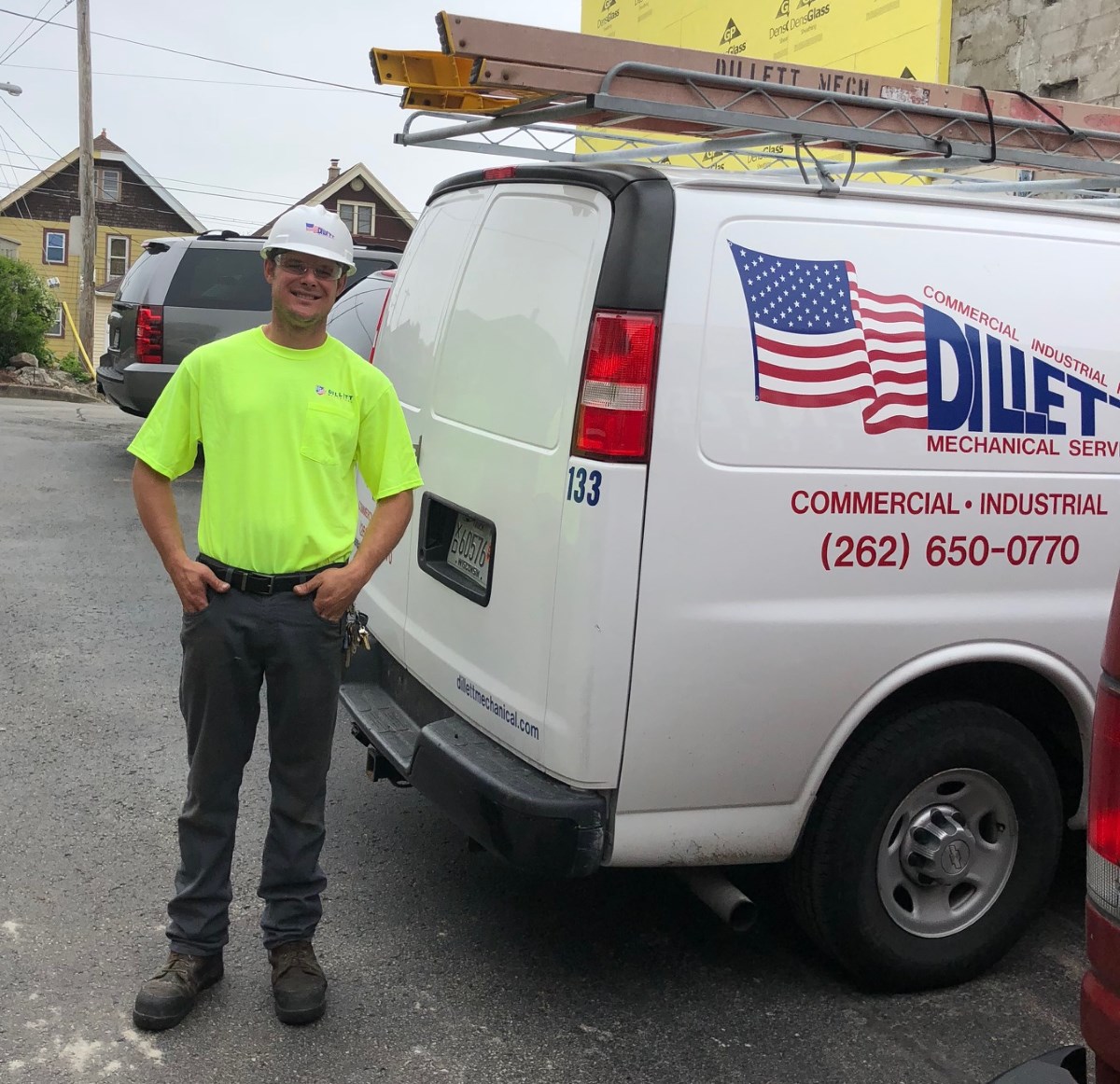 Dillett Mechanical Service Technician next to Dillett Mechanical van